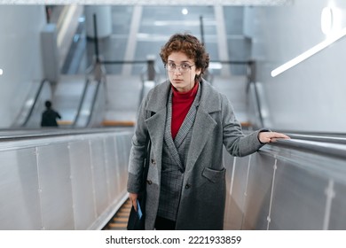 Business Woman Climbing The Escalator Steps In The Subway.