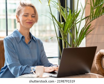  Business Woman In A Coffee Shop Working With A Laptop. New Business, Female Entrepreneur