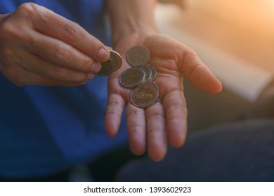 Business woman counting money coin in hands