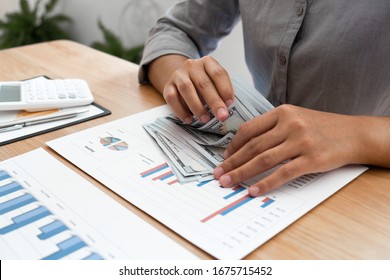Business woman is counting money and plan to using reserve money for business. financial, accounting concept. - Shutterstock ID 1675715452