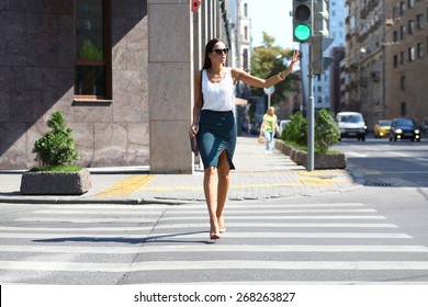 Business Woman Crossing The Road Outside In Sunny Weather