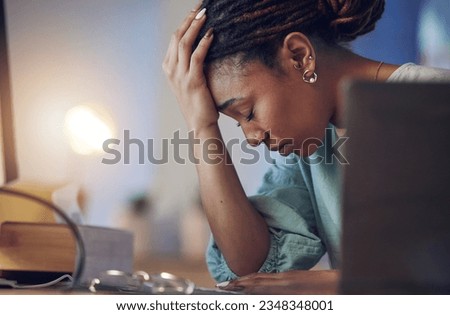 Business woman, depression and stress in an office at night working late on deadline. Tired African entrepreneur person with hands on head for pain, burnout or regret for mistake or fail at work
