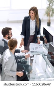 Business Woman Discusses With The Business Team Financial Performance