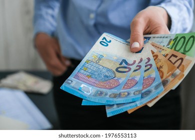 Business Woman Displaying A Spread Of Cash Euros. Close-up. Income And Business Concept. Venality, Bribe, Corruption Concept. Hand Giving Money. Millennial Candid Authentic Female Hands Counting Money