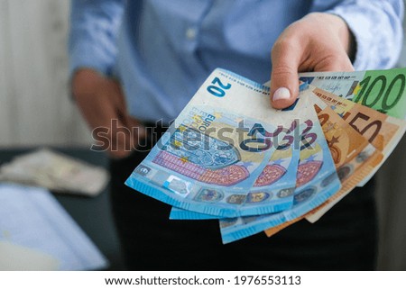 Business Woman Displaying a Spread of Cash euros. Close-up. Income and Business concept. Venality, bribe, corruption concept. Hand giving money. Millennial candid authentic female hands counting money