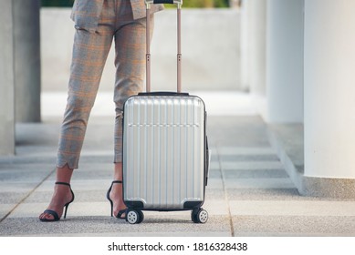 Business woman Dragging suitcase luggage bag,walk to passenger boarding in Airport.Working woman travel to work,wear suit pull trolley bag. Businesswoman Travel concept-panoramic banner for web header