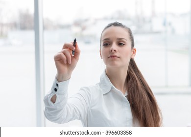 Business Woman Drawing A Concept Diagram On Transparent Screen