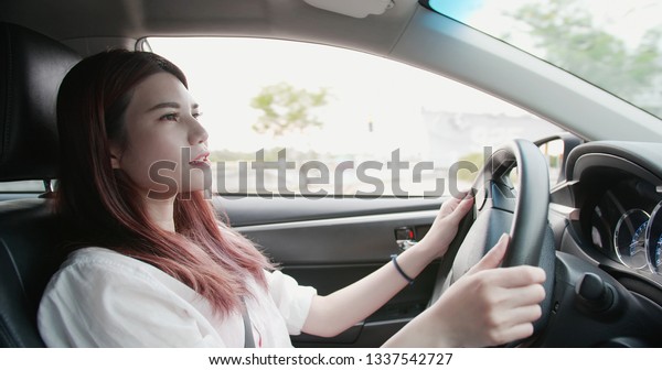 business woman driving\
happily in the car