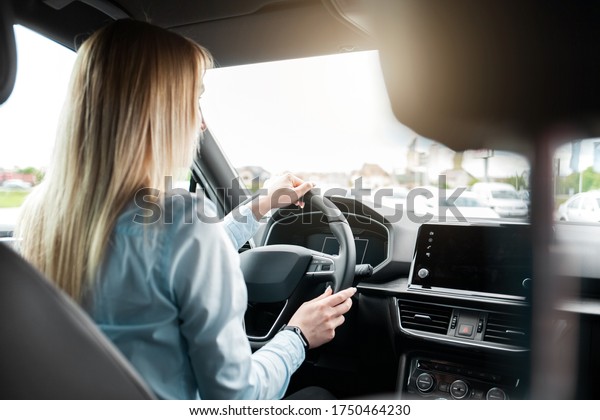 Business woman driving a\
modern car