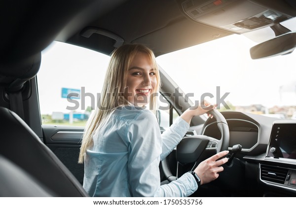Business woman driving a\
modern car