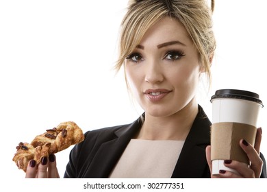 Business Woman Eating A Pasty And Drinking A Coffee To Start Her Day 