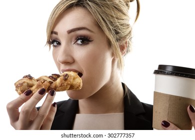 Business Woman Eating A Pasty And Drinking A Coffee To Start Her Day 