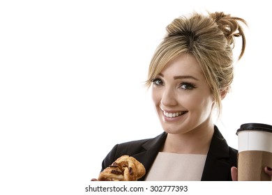 Business Woman Eating A Pasty And Drinking A Coffee To Start Her Day 