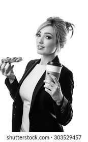 Business Woman Eating A Pasty And Drinking A Coffee To Start Her Day 