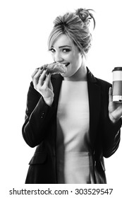 Business Woman Eating A Pasty And Drinking A Coffee To Start Her Day 