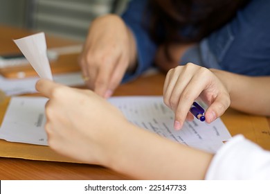 Business woman filling document agreement form in office.