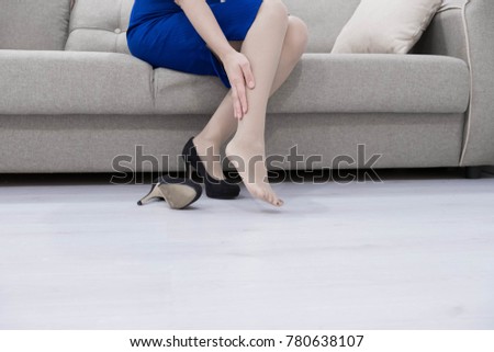 Business woman, foot, tired, swelling, shoes. Woman doing self massage