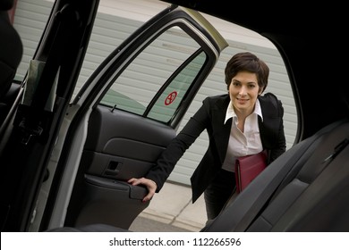 A Business Woman Gets In The Back Seat Of Taxi Cab Downtown Urban Traveler