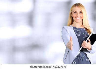 Business Woman Giving A Hand/ Handshake  In The Office