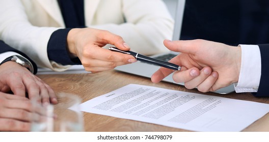 Business Woman Giving Pen To Businessman Ready To Sign Contract. Success Communication At Meeting Or Negotiation