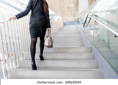 Business Woman Going Up The Stairs