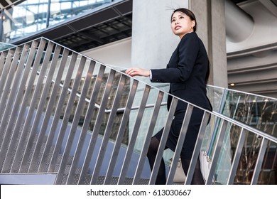 Business Woman Going Up The Stairs Side View