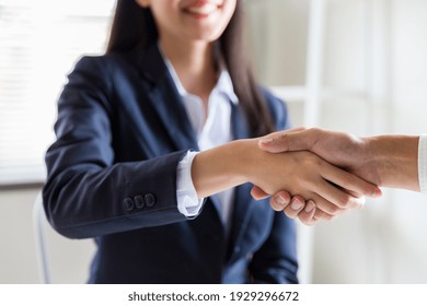 Business woman greeting with shake hands to congratulate after agreement with partner. Two business partners greeting together - Powered by Shutterstock