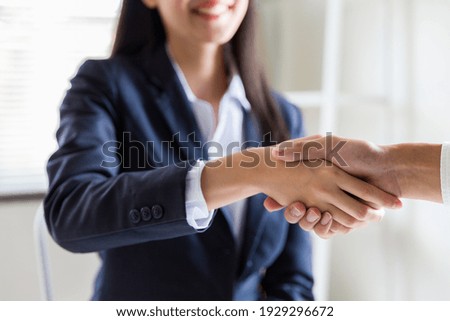 Similar – Image, Stock Photo Two young men shake hands. Close up of the hands in front of a green background.