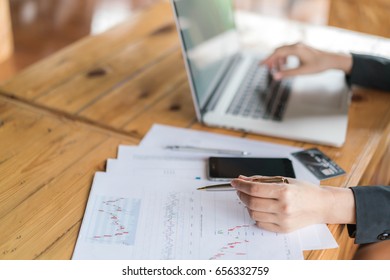 Business woman hand with Financial charts and laptop on the table - Shutterstock ID 656332759