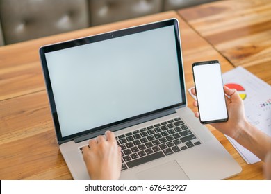 Geschäftsfrau mit Finanzkarten und Mobiltelefon auf dem Tisch