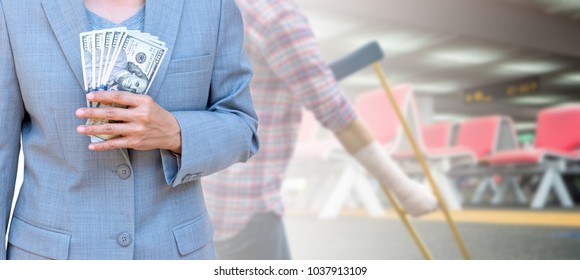 Business woman hand holding American dollar Currency isolated on blurred woman using crutches for patient broken leg with row of seats in departure area at airport terminal, health care cost