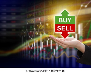 Business woman hand holding buy or sell on stock market background