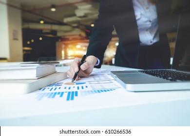 Business woman hand pointing  business document during discussion at meeting discussion and analysis data the charts and graphs showing the results at meeting.Business finances and accounting concept - Shutterstock ID 610266536