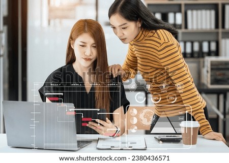Business woman hand Project manager working and update tasks and Gantt chart scheduling virtual diagram.with smart phone, tablet and laptop in office.