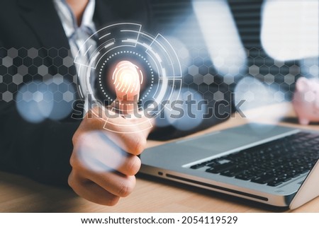 Business woman hand using fingerprint indentification to access personal financial data, Fingerprint scan provides security access with biometrics identification.