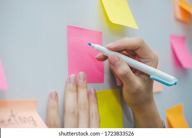 business woman hand writing with colored sheets sticky note paper on white board background in home office, business meeting, brainstorming, creative, digital online marketing, financial concept - Shutterstock ID 1723833526