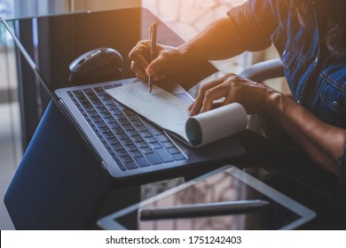 Business woman hand writing and signing white blank bank cheque book with laptop computer, mouse and digital tablet on the desk at office. Payment by check, paycheck, payroll concept.   - Shutterstock ID 1751242403