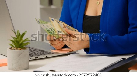 Business woman hands in blue jacket counting european currency at workplace. Female making sure by counting bill that she can afford a purchase.