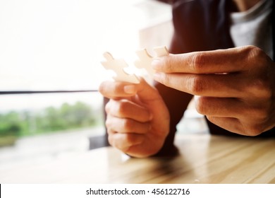 Business woman hands connecting jigsaw puzzle. Business solutions, success and strategy concept. Businessman hand connecting jigsaw puzzle.Close up photo with selective focus. - Shutterstock ID 456122716