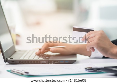 Business woman hands holding credit card and using laptop for online shopping. Online shopping concept.