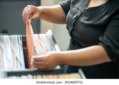 business woman hands searching information in Stack of papers files on work in office,