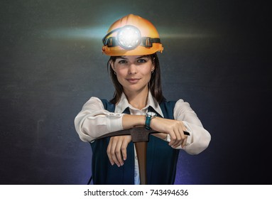 Business woman with helmet mine and pickaxe for bitcoin coins. Studio shoot. Mining cryptocurrency concept