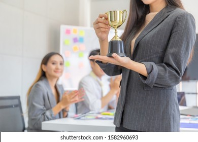 Business Woman Holding Award Trophy At Meeting Room, Celebration Success Happiness Team Concept