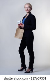 Business Woman Holding A Brown Paper Bag And A Takeaway Cup On Her Lunch Break