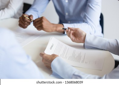 Business woman holding checking benefit reading legal paper form at group meeting, client customer negotiating on contract terms at table ready to make agreement sign document concept, close up view