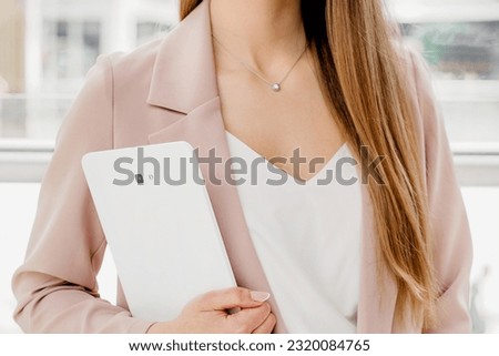 business woman holding digital tablet standing in the business center