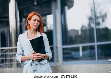 Business woman holding folder by the office center - Shutterstock ID 1761796202