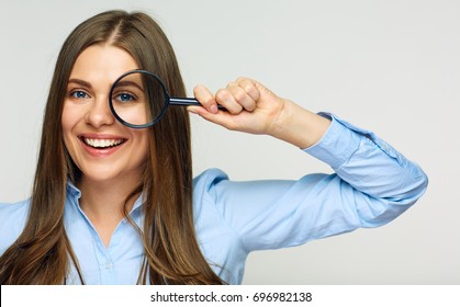 Business Woman Holding Magnifying Glass Behind Eyes. Smiling Business Woman Isolated Portrait.