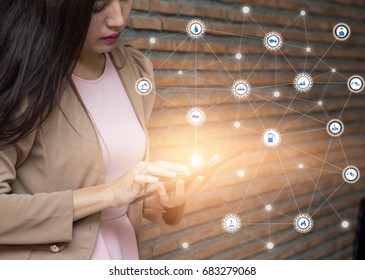 Business Woman Holding On Mobile Smartphone Or Cell Phone With Icons. Modern Lifestyle, Internet Of Things Concept, Iot. Oil Refinery Icons And Buyer.