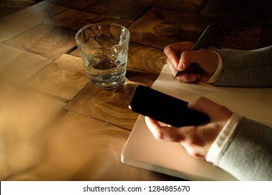 Business woman holding a phone in her hands. - Shutterstock ID 1284885670